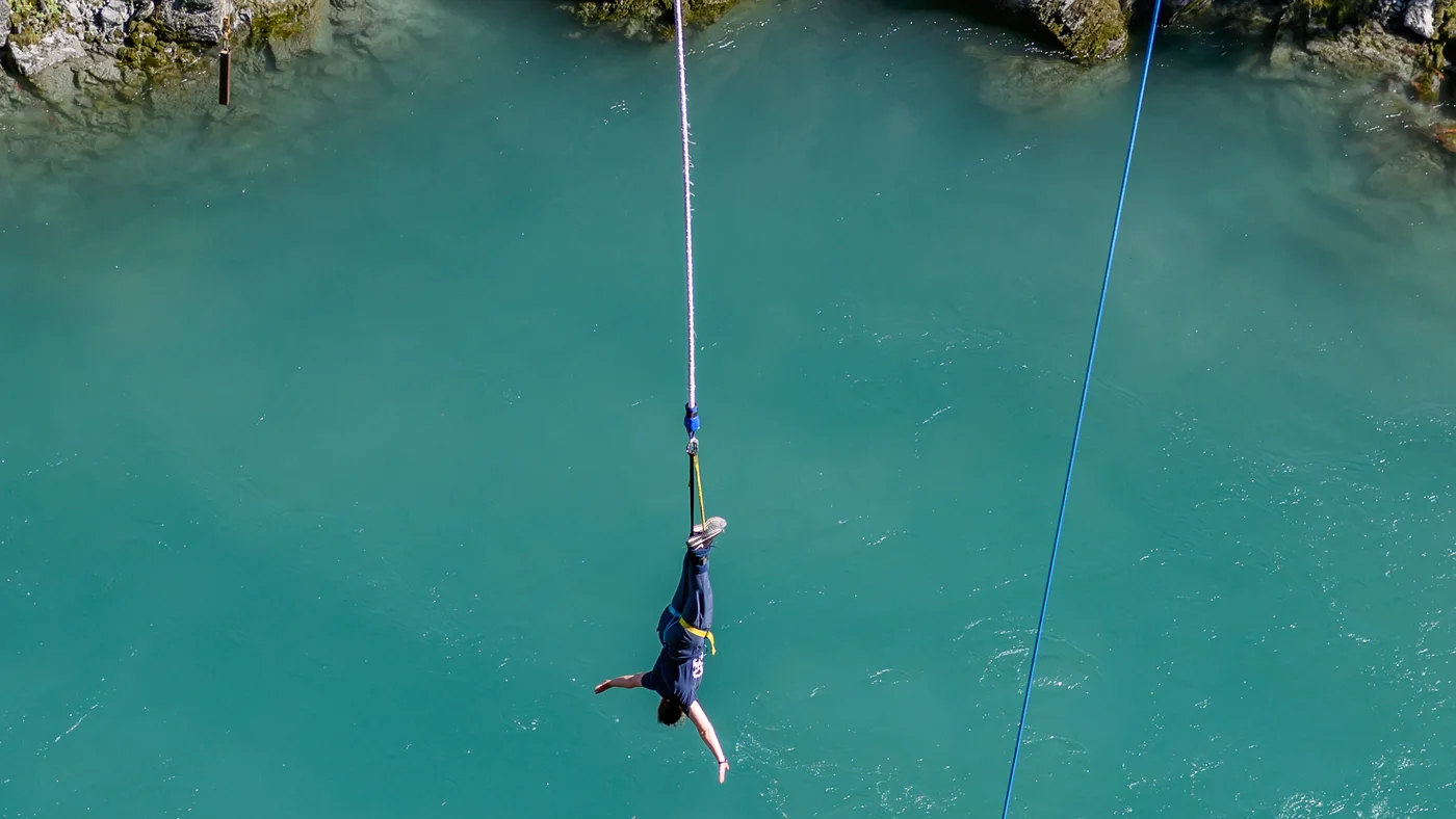 Archive photograph of a bungy jumper suspended above the Kawarau River in 2019