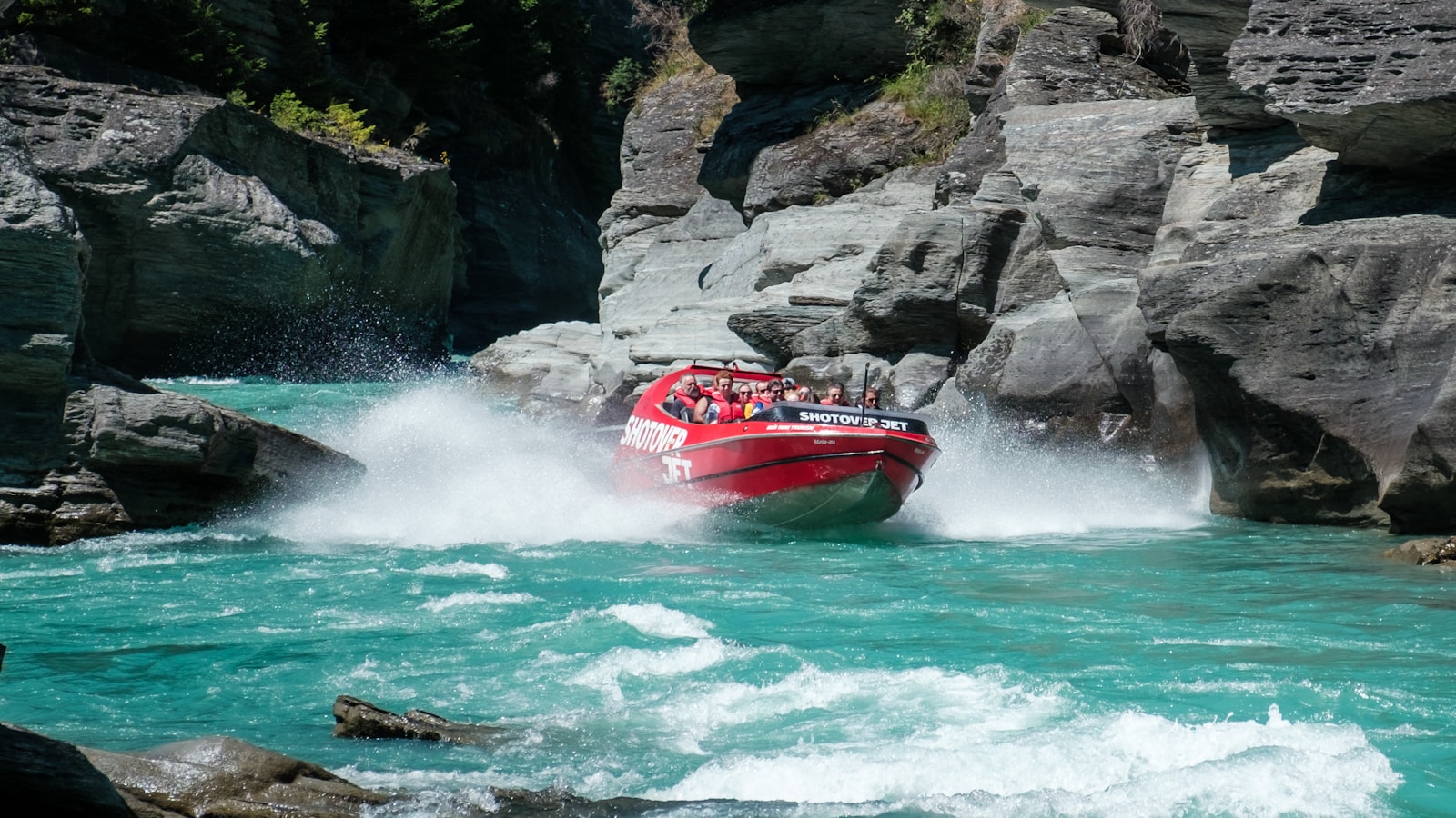 Iconic red Queenstown jet boat on the Shotover — a day in town must-do