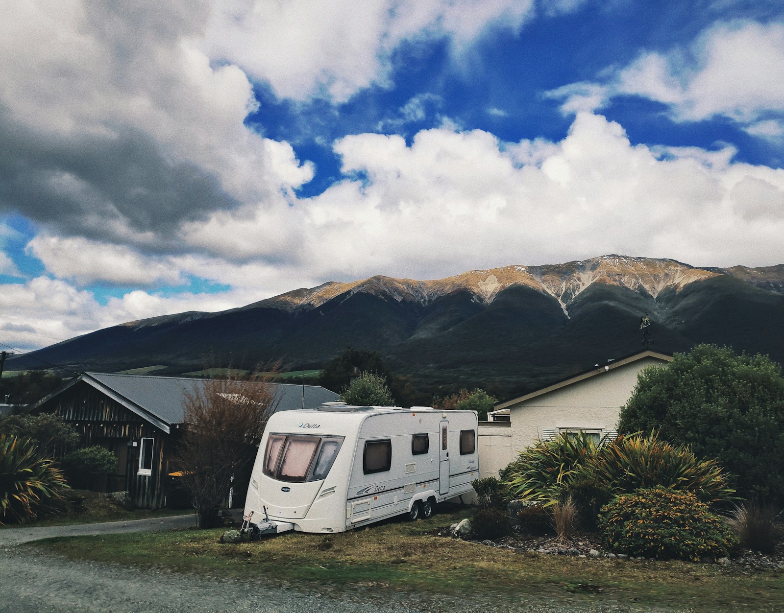 Campervan parked under New Zealand alpine sky — the budget travellers' classic